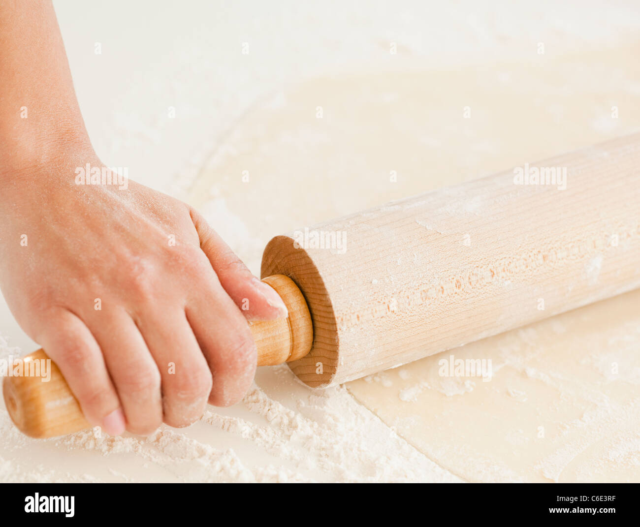 USA, New Jersey, Jersey City, Close up of woman's hand preparing dough with roller pin Stock Photo