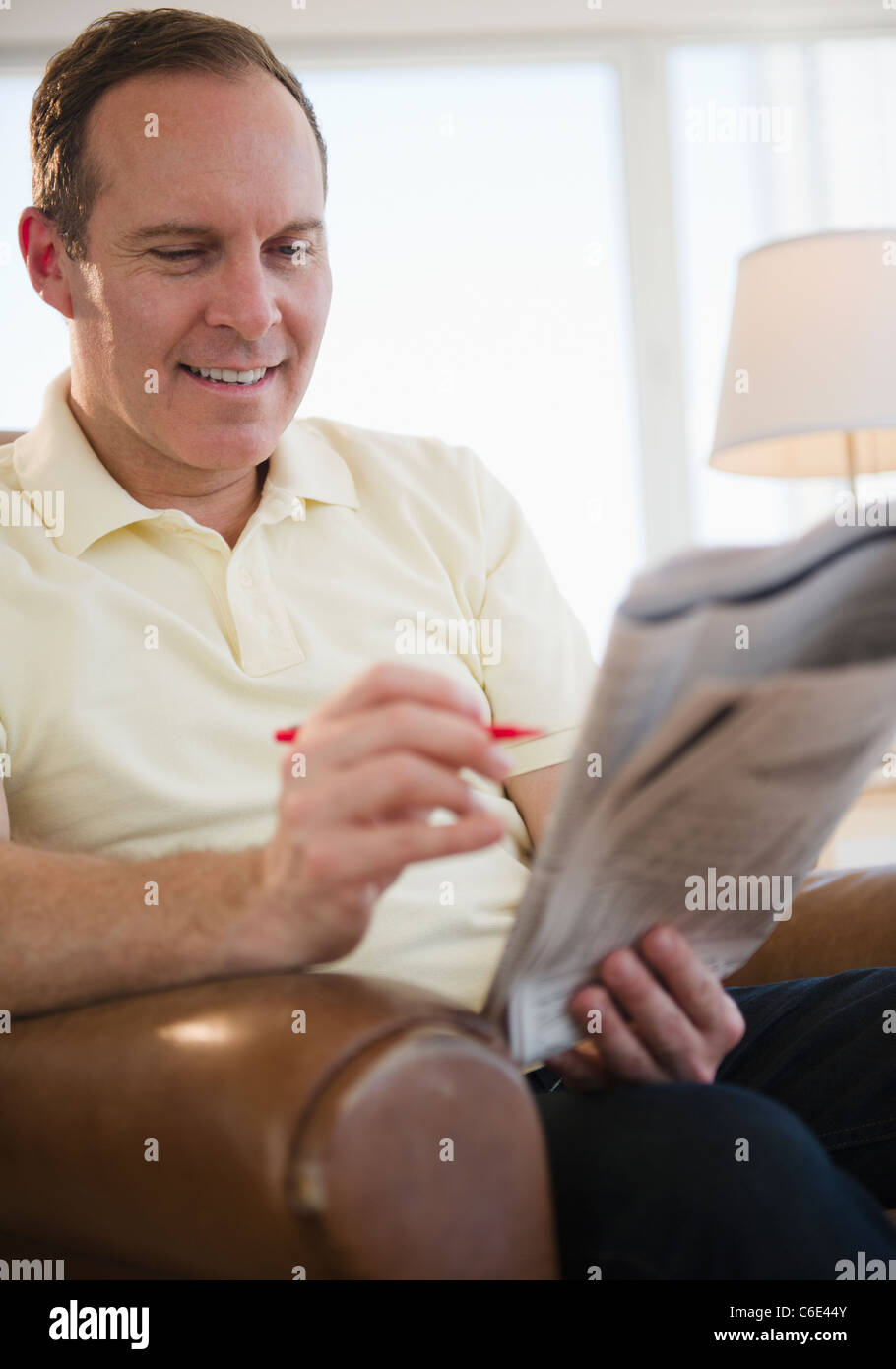 USA, New Jersey, Jersey City, Man reading job adverts in newspaper Stock Photo