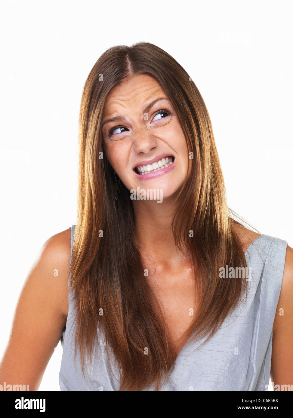 Beautiful woman with fake smile looking away Stock Photo