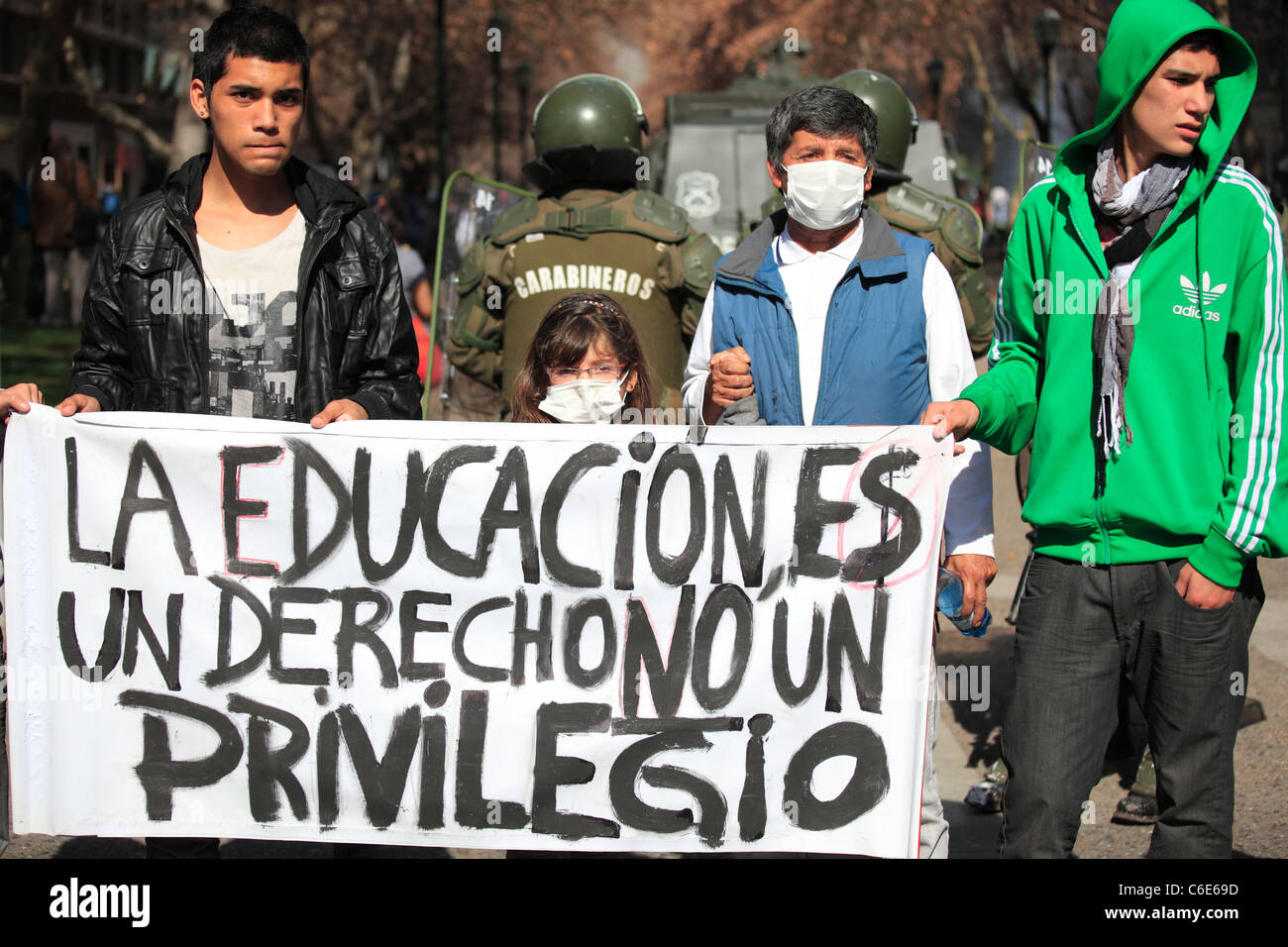 Demonstrators hold a banner that says 
