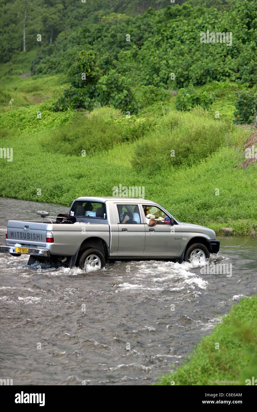 SUV vehicle crossing stream in Teahupoo, Tahiti, French Polynesia Stock