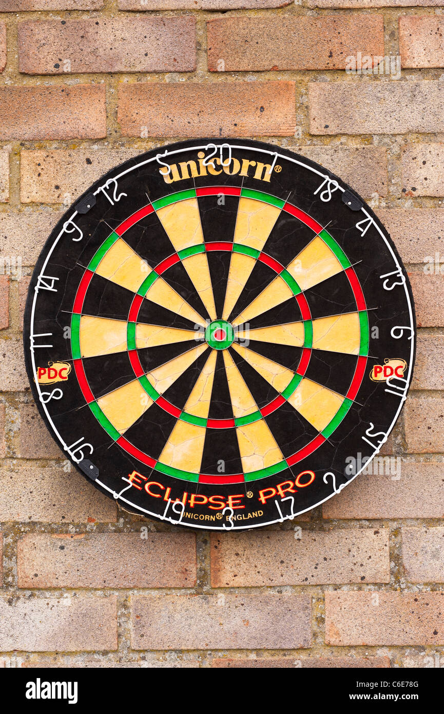 A dartboard on an exterior wall Stock Photo