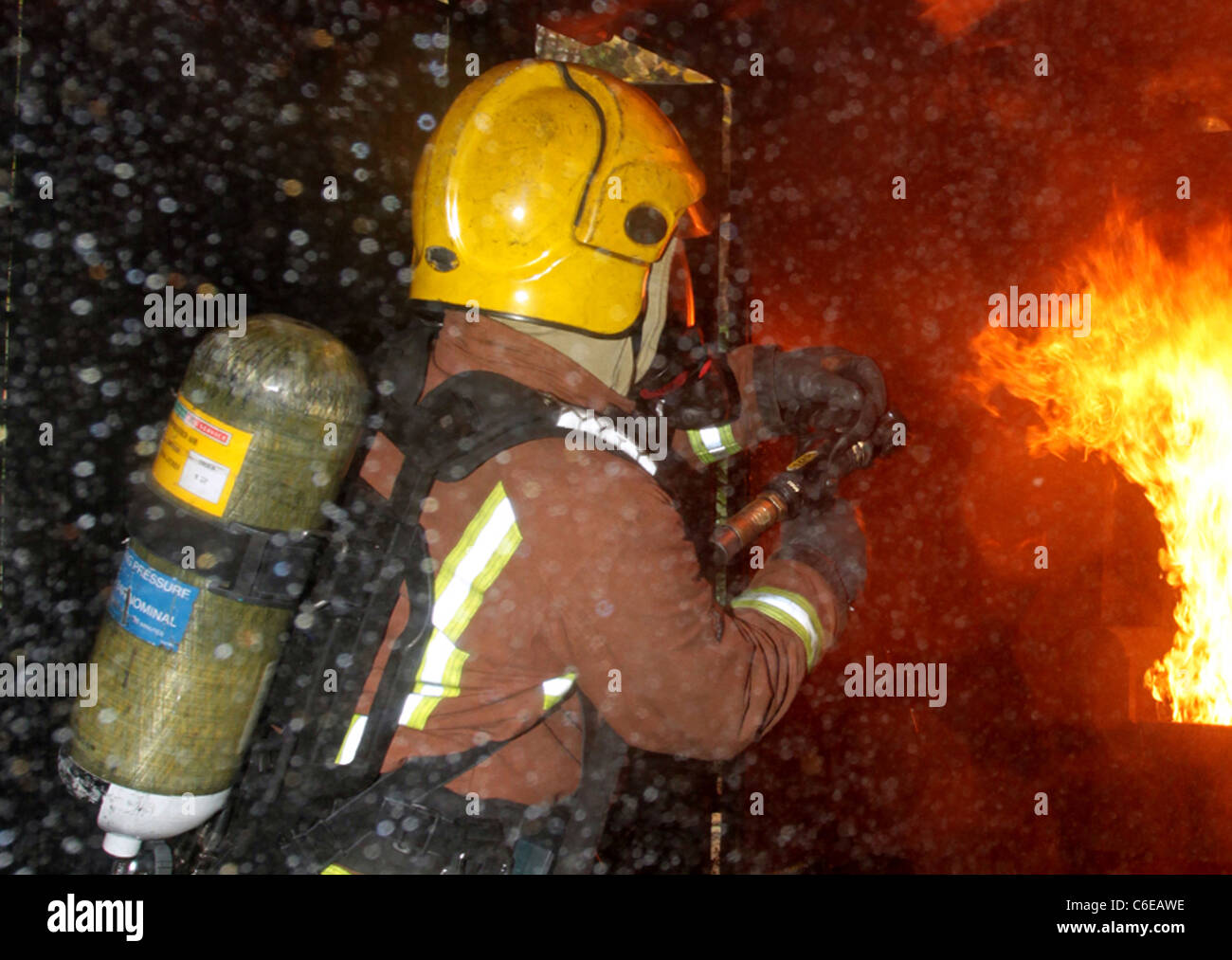 firefighter tackles fire west midlands fire service Stock Photo