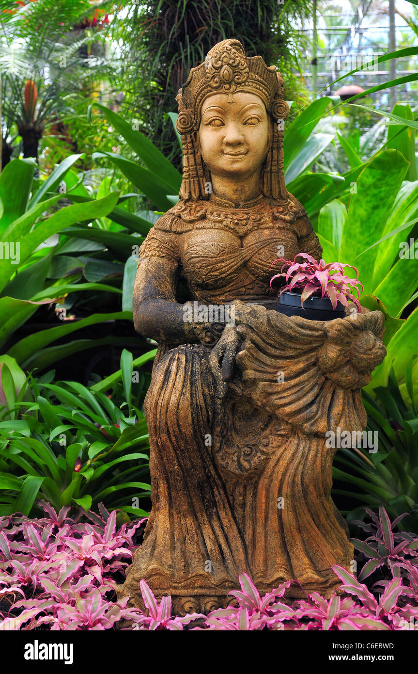 Buddha Statue Close up of a smiling buddhist goddess between green