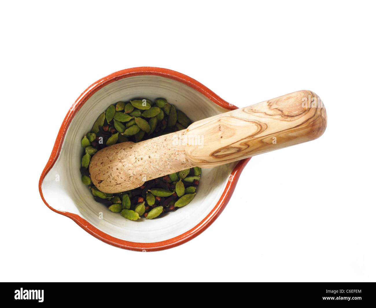 Studio shot of mortar and pestle with cardamom seeds Stock Photo Alamy