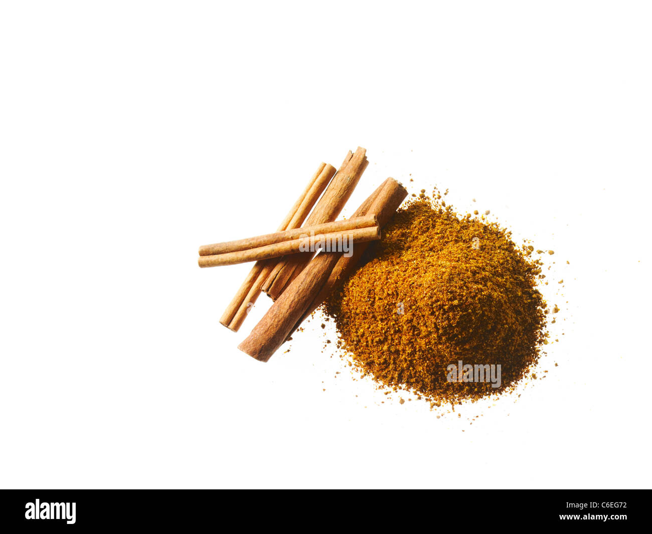 Studio shot of Ground Cinnamon and Cinnamon Sticks on white background Stock Photo