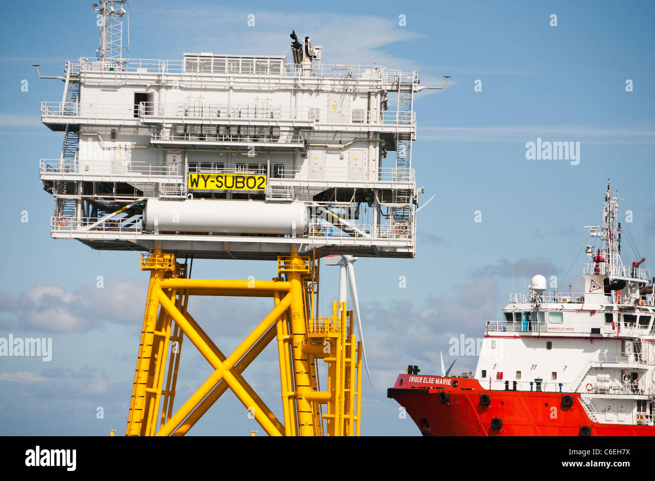 A cable laying vessel next to a sub station at the Walney offshore wind farm, Stock Photo