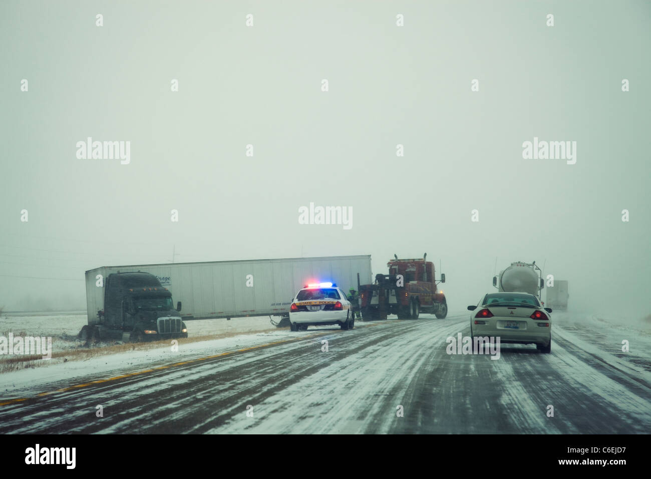 USA, Illinois, Springfield, Semi truck accident on highway during storm Stock Photo