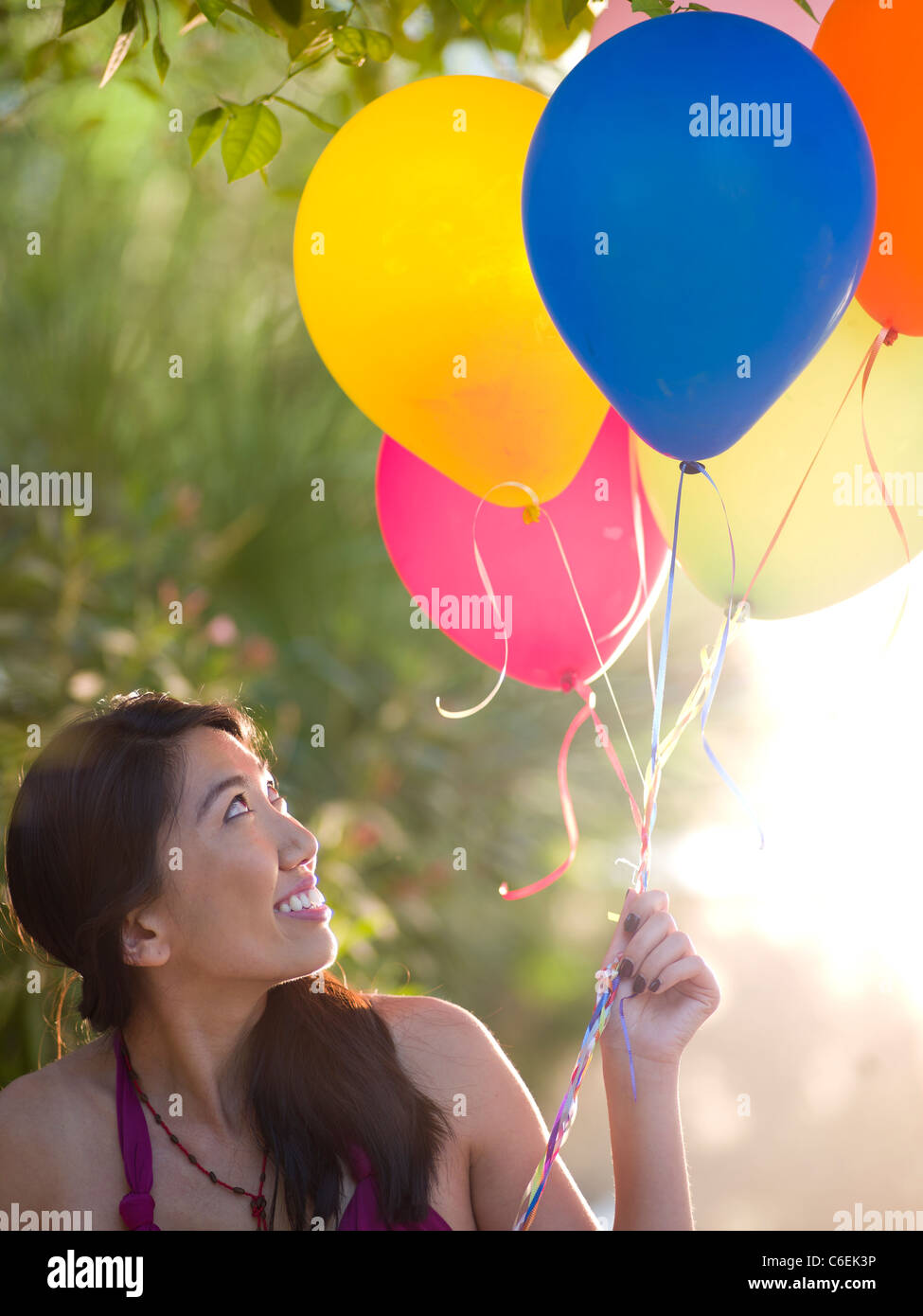 USA, Arizona, Scottsdale, Mid adult woman holding balloons Stock Photo