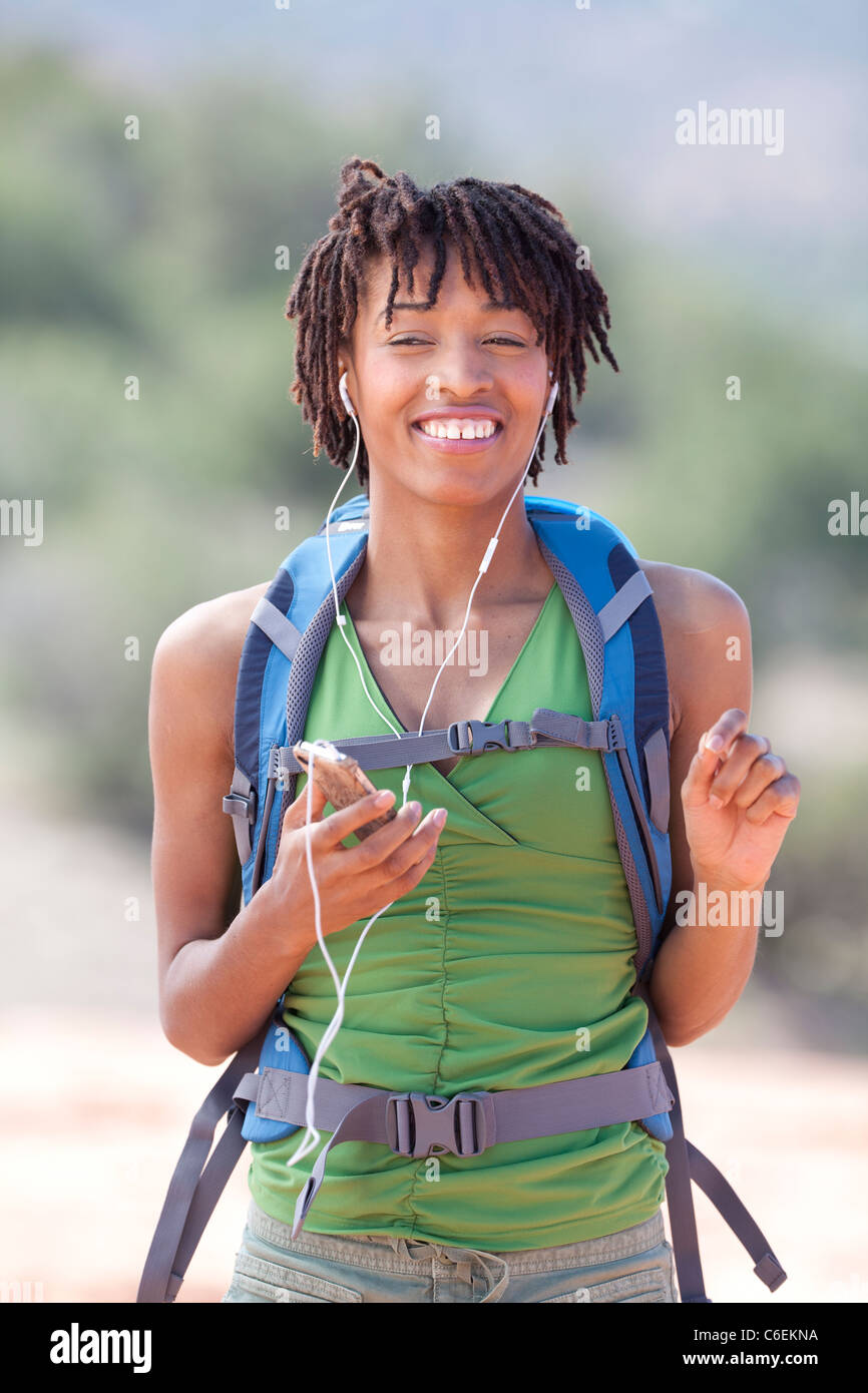 USA, Arizona, Sedona, Smiling female hiker listening music Stock Photo