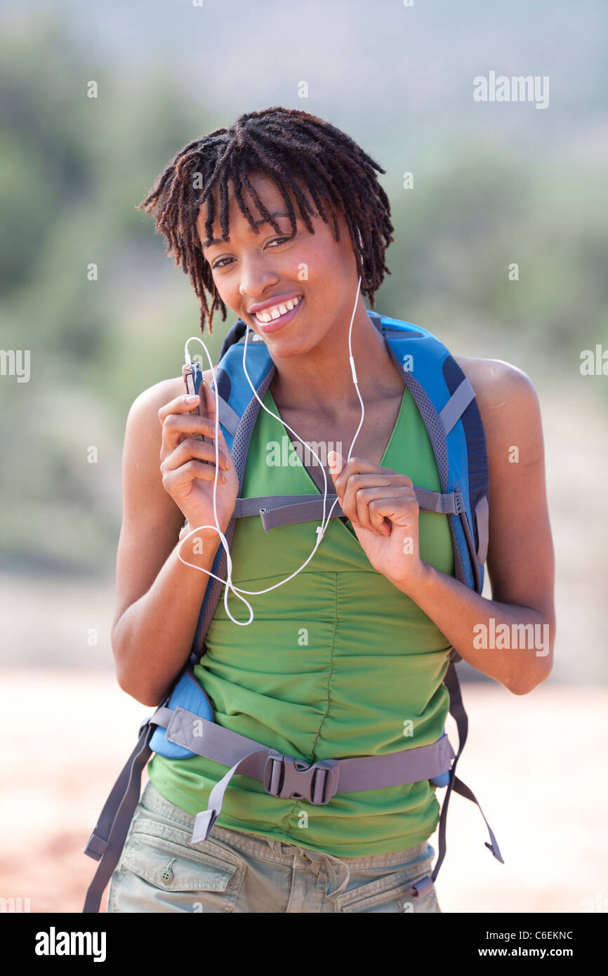 USA, Arizona, Sedona, Smiling female hiker listening music Stock Photo
