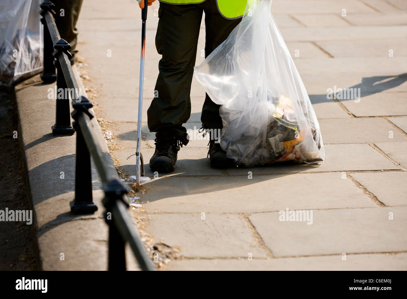 A man collecting rubbish from the street Stock Photo