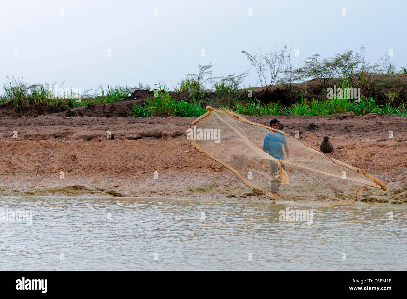 man cast casting throw throwing net fishing hand Tonle Sap