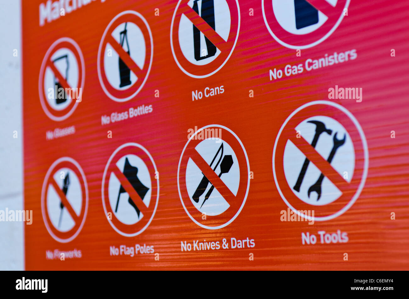 List of banned items on a notice board outside the entrance to a football stadium Stock Photo