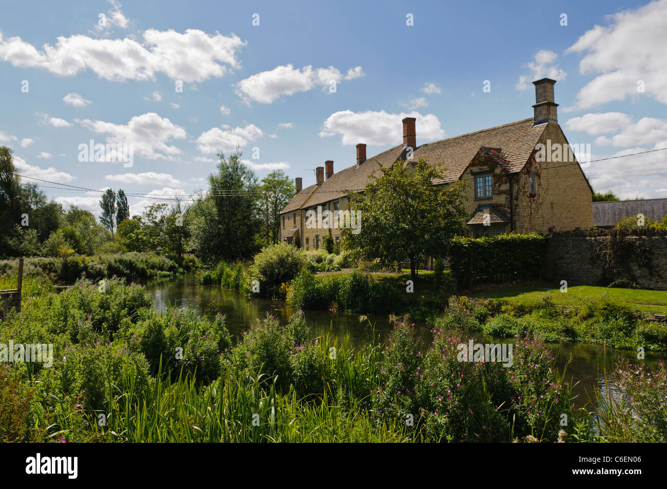 Houses beside the River Coln in the Gloucestershire village of Fairford