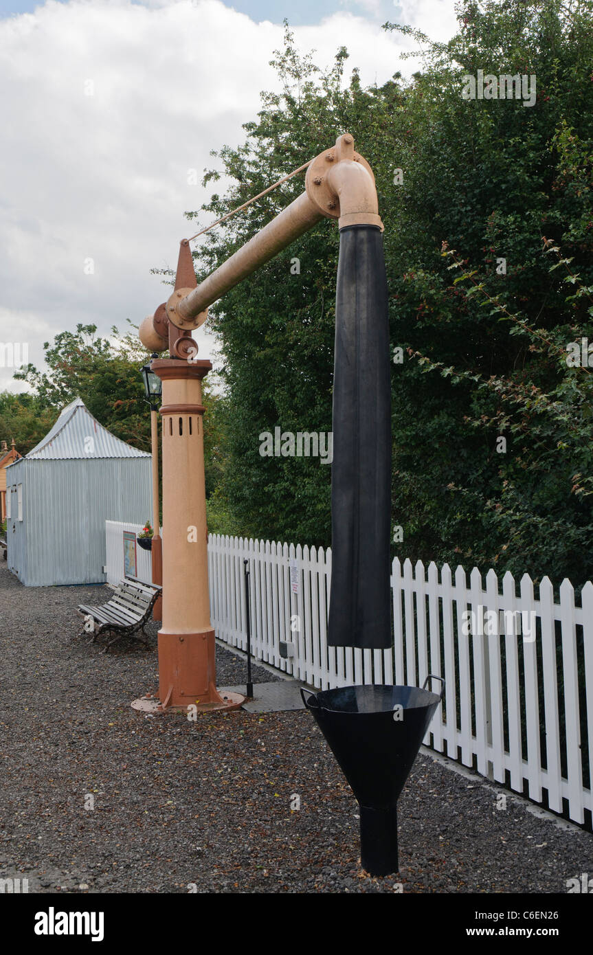Water crane (standpipe) on the platform of a train station for steam engines to refill with water Stock Photo