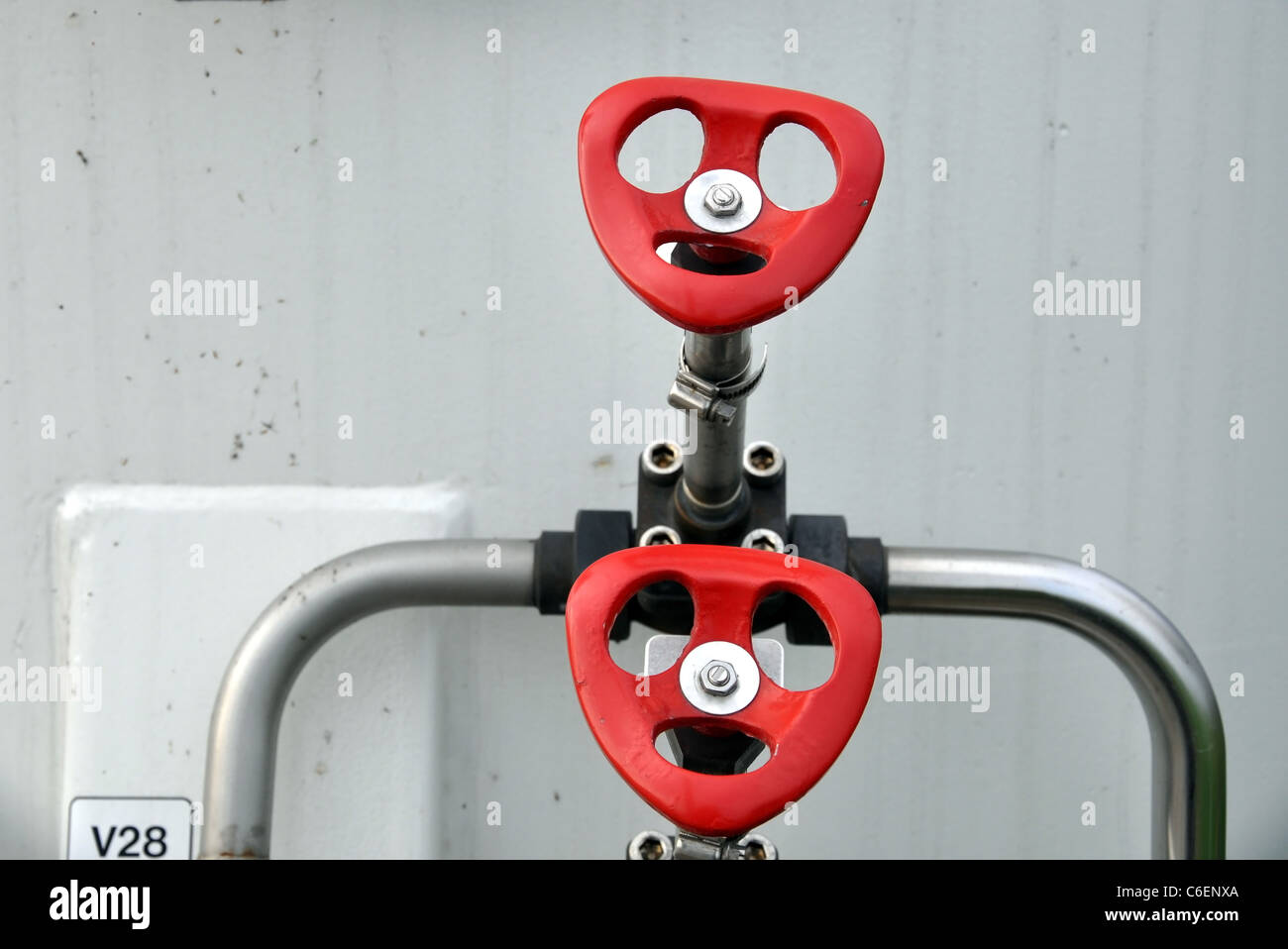 Red handles on valves of the pipeline Stock Photo