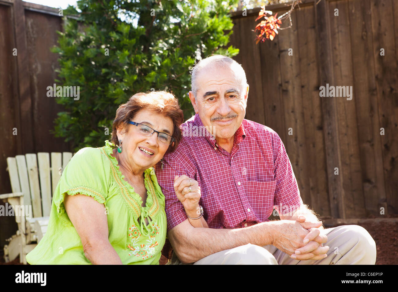 Senior Hispanic couple sitting together outdoors Stock Photo - Alamy