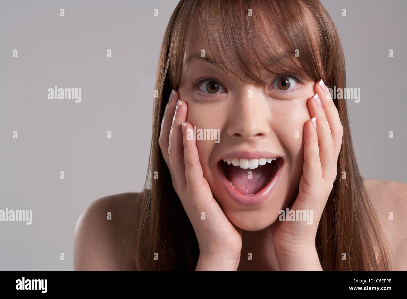 Portrait of young surprised woman, studio shot Stock Photo - Alamy