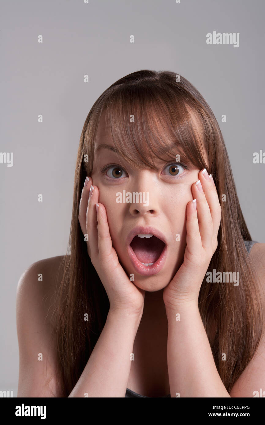 Portrait of young surprised woman, studio shot Stock Photo - Alamy