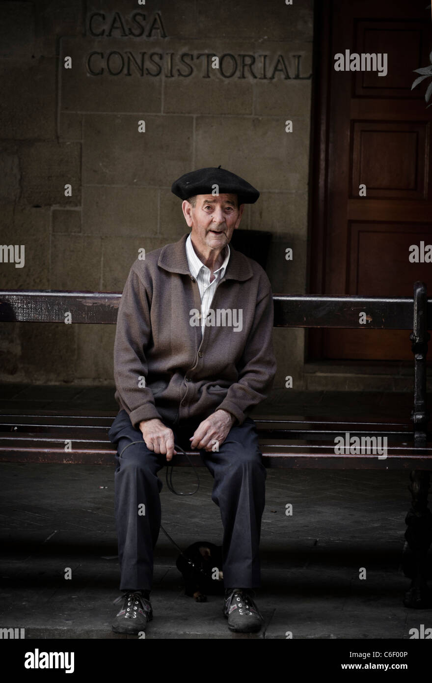 Old man resting on a bench in La Guardia, Rioja, Spain Stock Photo
