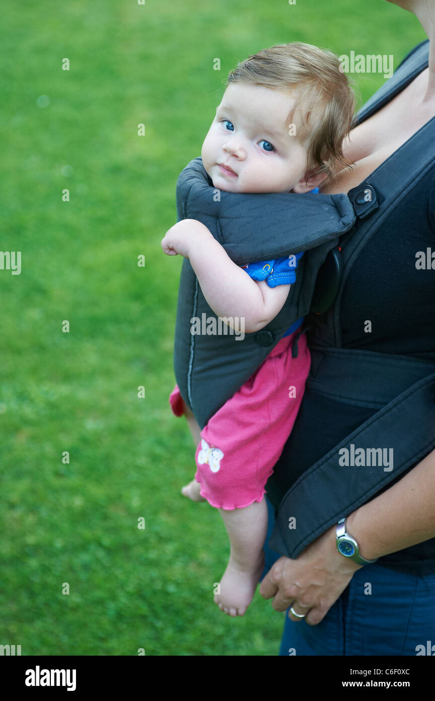 Mother carrying baby in baby carrier outside Stock Photo Alamy