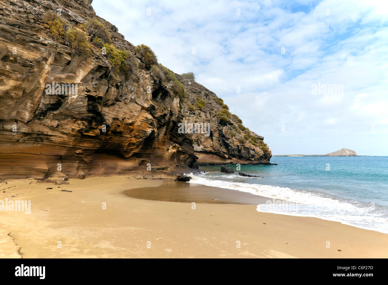 Beach and rocky cliff at Punta Pitt, San Christobel, Galapagos Stock Photo