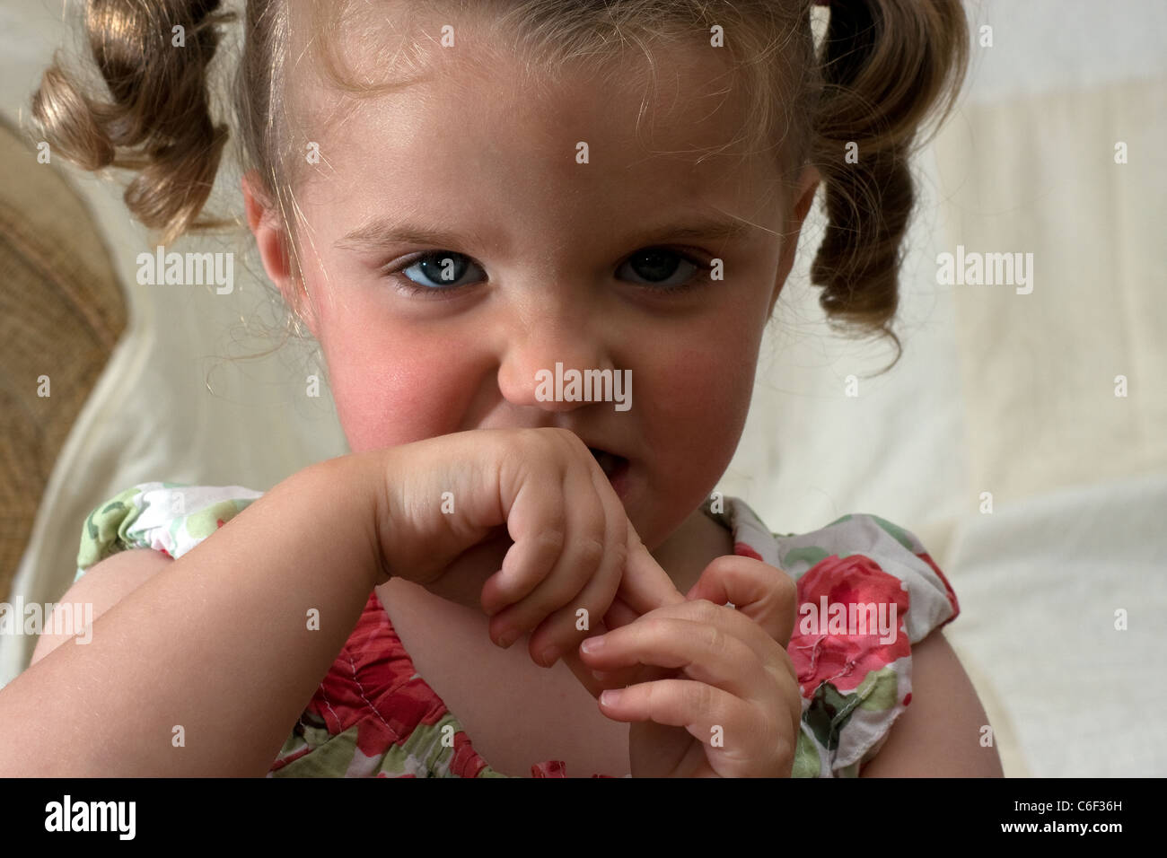 young toddlers girl smile smiling cute scowl Stock Photo