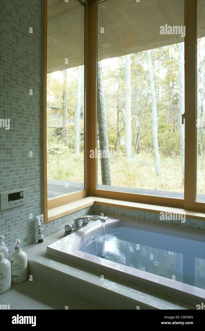 Bath tub in a japanese bathroom with a window toward the wood Stock ...