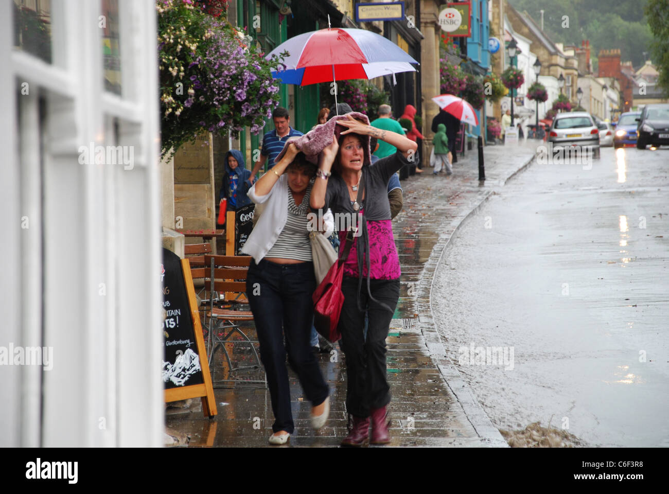 tourists in rainy Glastonbury, United Kingdom Stock Photo