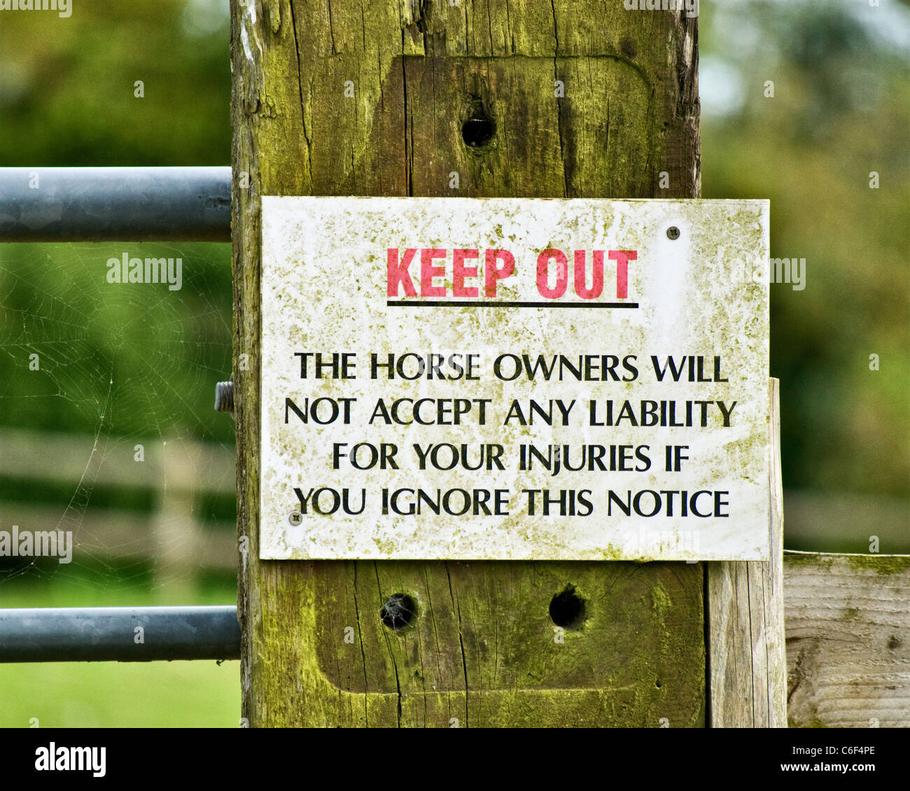 Sign, Keep out, The horse owners will not accept any liability for your injuries if you ignore this notice Stock Photo