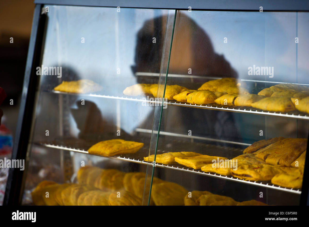 Pastry display case with customer reflection Stock Photo