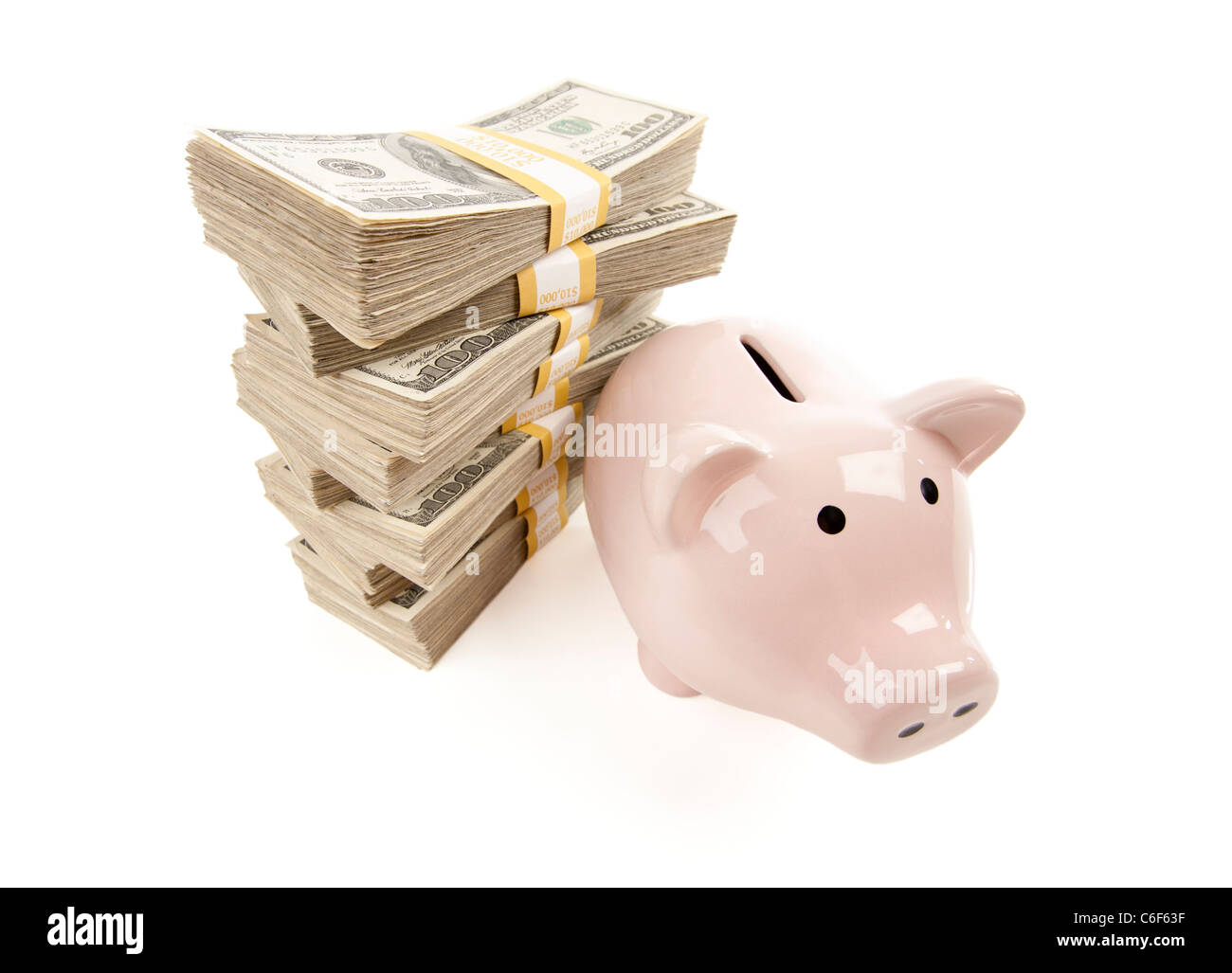 Pink Piggy Bank with Stacks of Hundreds of Dollars Isolated on a White Background. Stock Photo