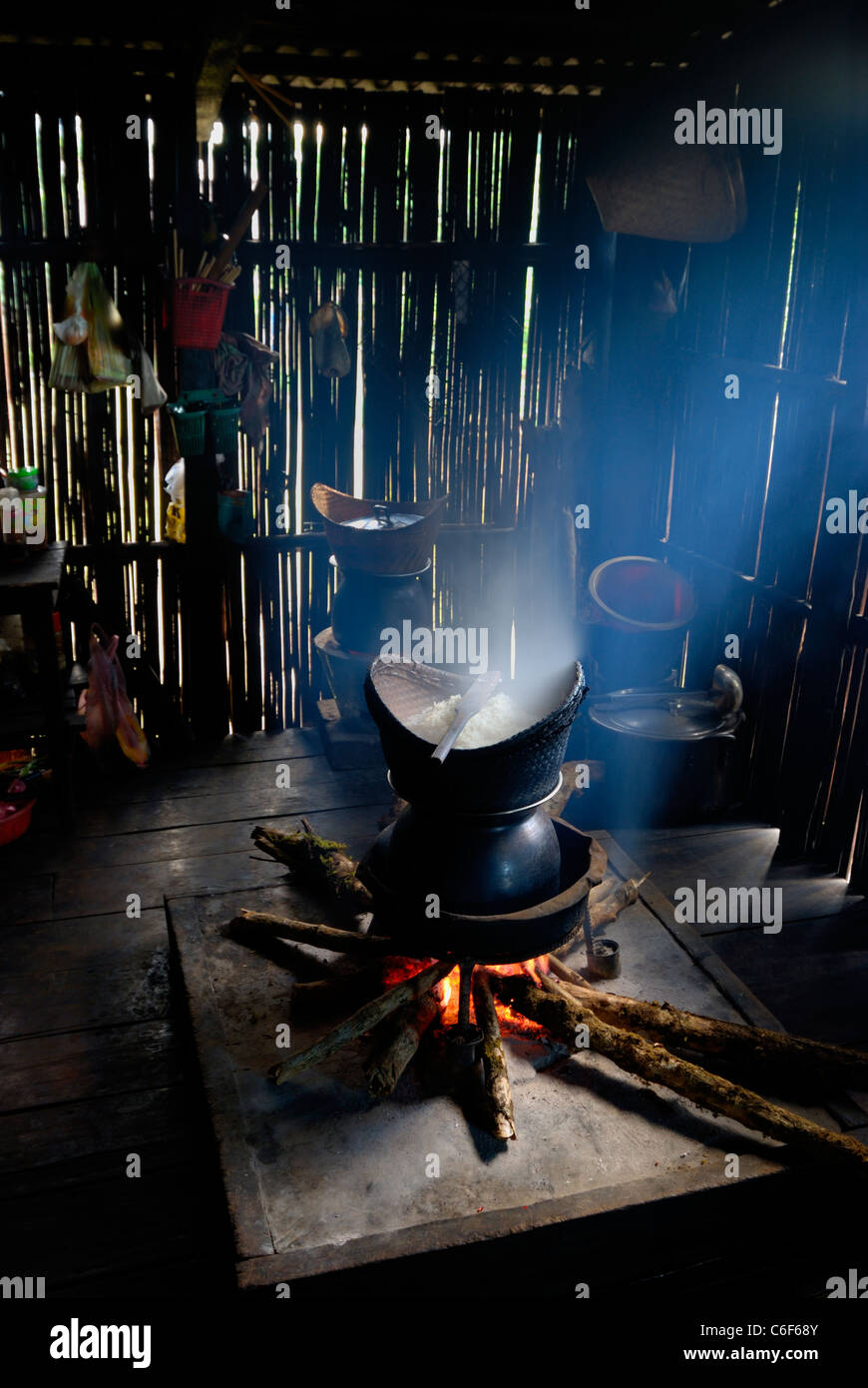 Steamer pot and sticky rice basket in a rural, wooden kitchen of a house in Nong Luang village, Bolaven plateau, Champasak, Laos Stock Photo