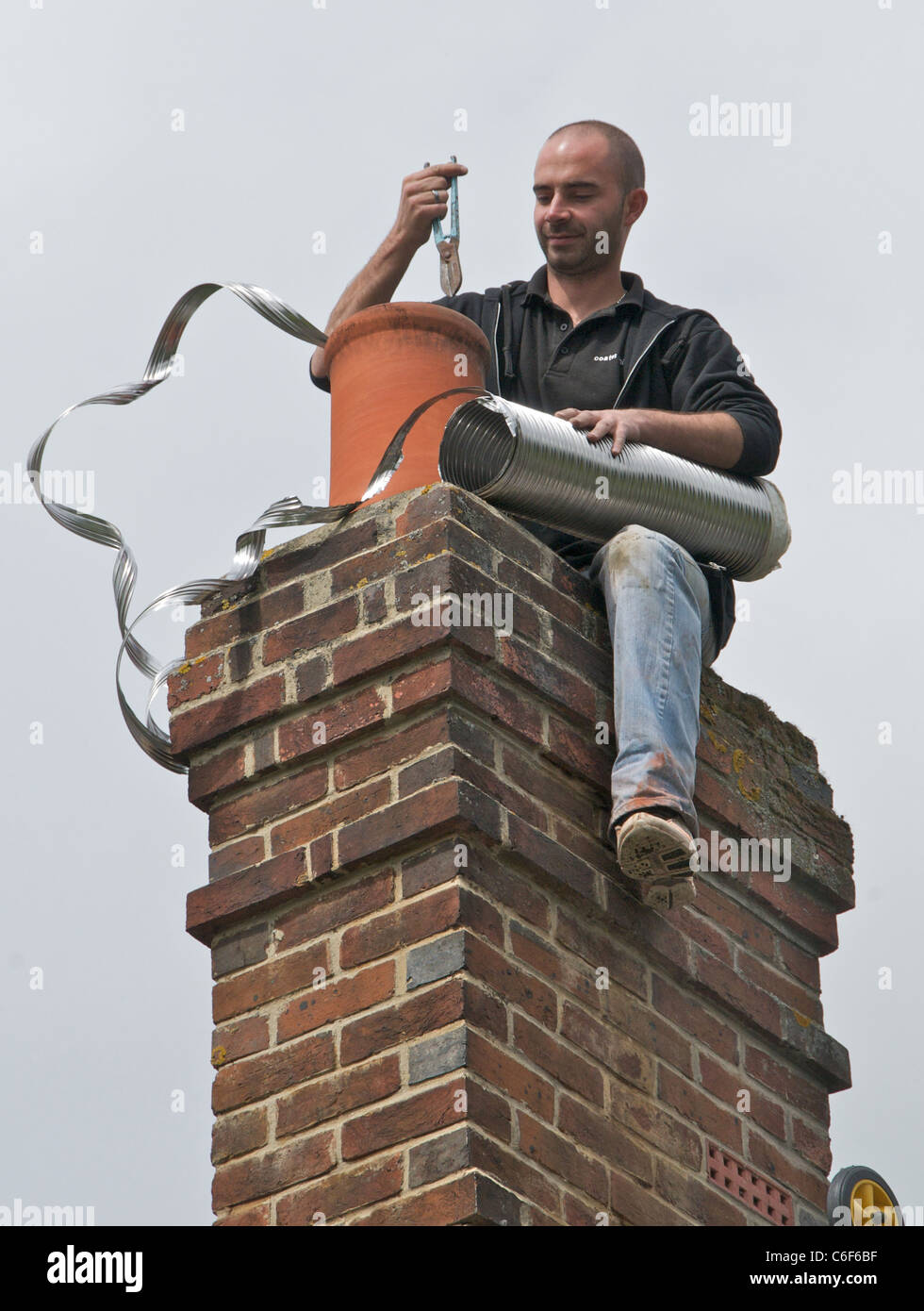 Lining a chimney for wood burning Stock Photo Alamy