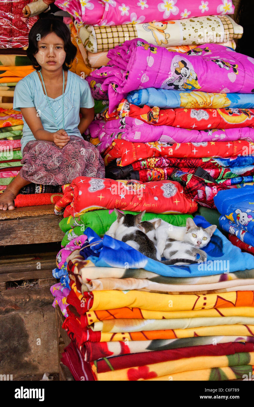 Girl selling bedding in market, Bago (Pegu), Myanmar (Burma Stock Photo