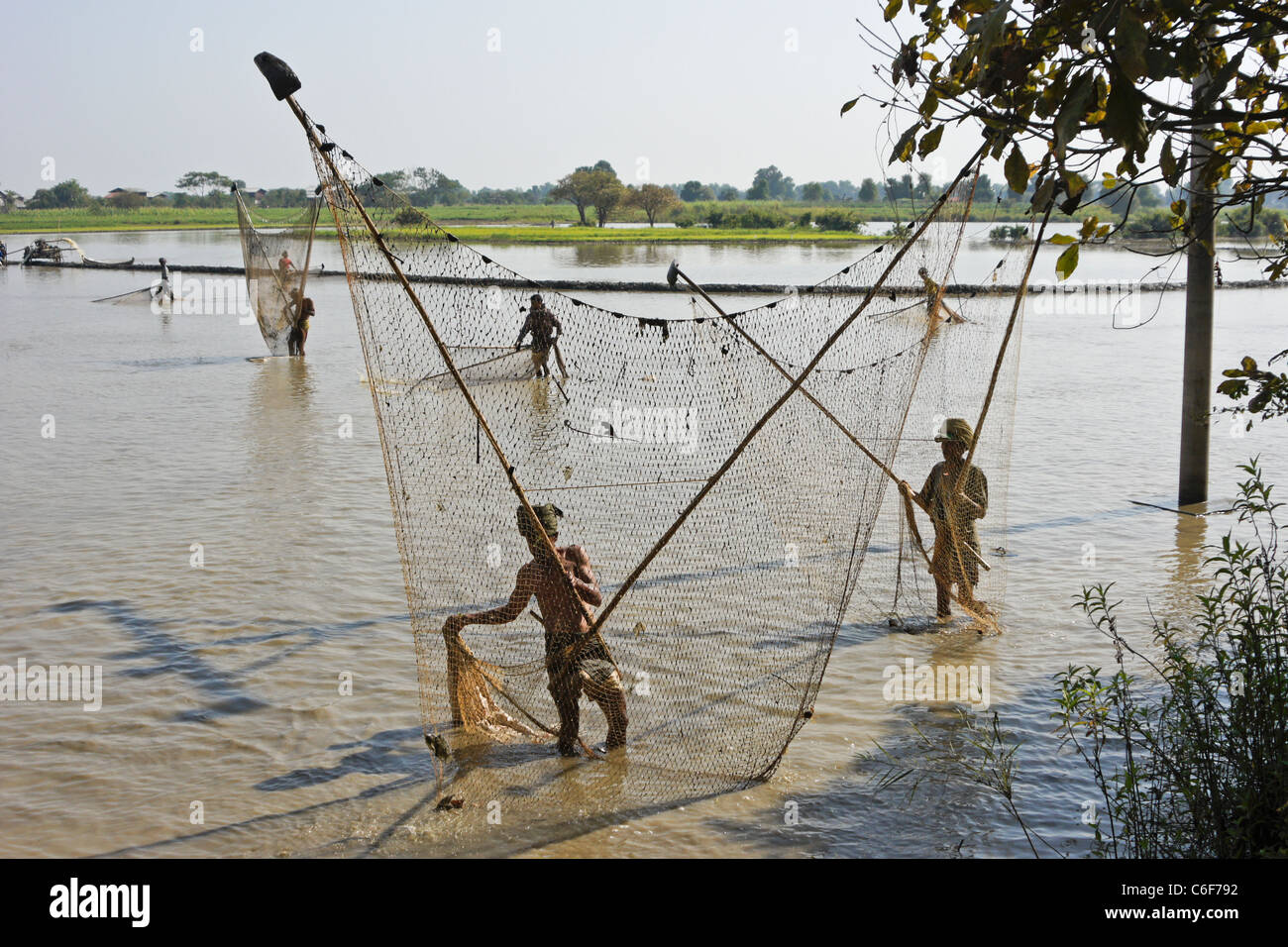 Men fishing with large nets and poles, Mandalay, Myanmar (Burma