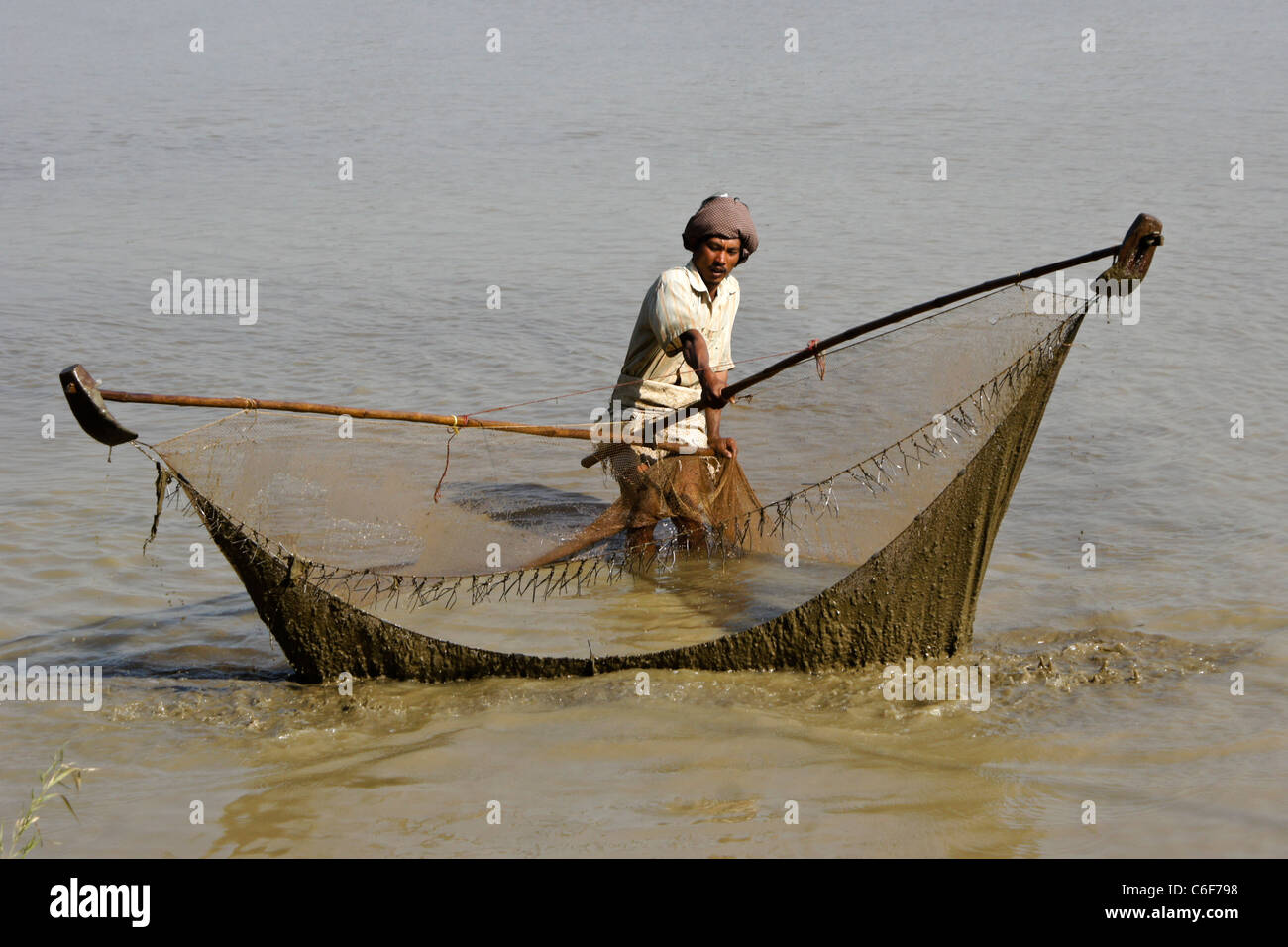 Man fishing with large net and poles, Mandalay, Myanmar (Burma