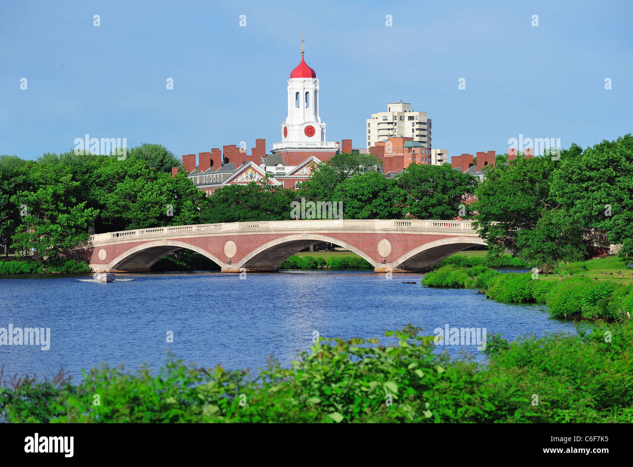 John W. Weeks Bridge and clock tower over Charles River in Harvard University campus in Boston with trees and blue sky. Stock Photo