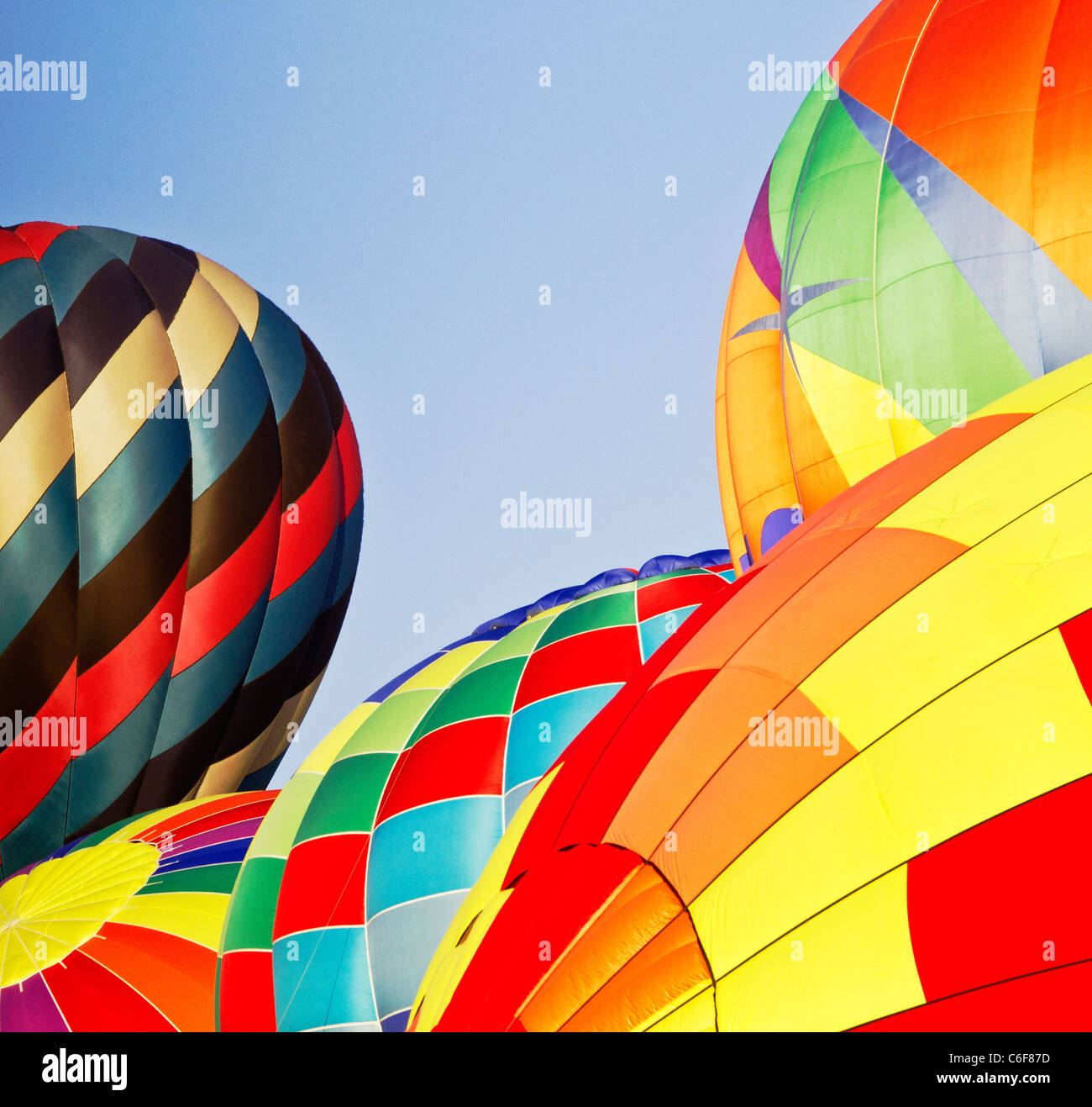 Five, hot air balloons inflating for a morning ascension; copy space center and left; New Jersey Festival of Ballooning. Stock Photo