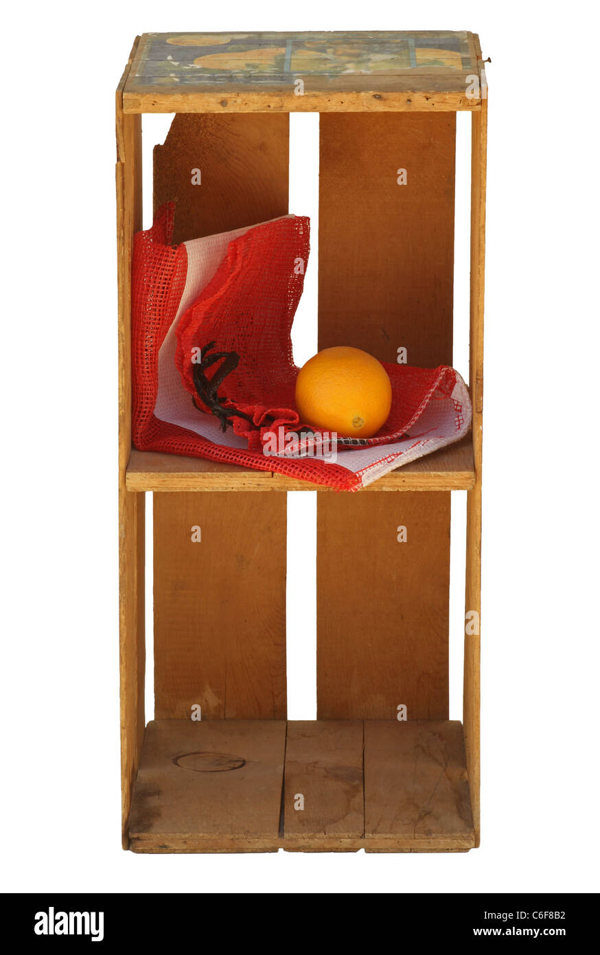 Upright wood crate isolated with net fruit  bag and orange fruit inside. Isolated. Stock Photo