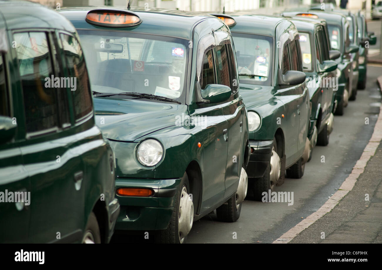 Line up of green hackney cabs Stock Photo