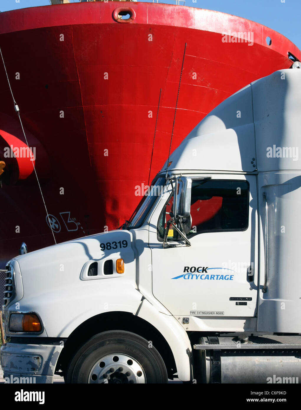 Canadian cargo truck passes a cargo ship on the waterfront in Toronto