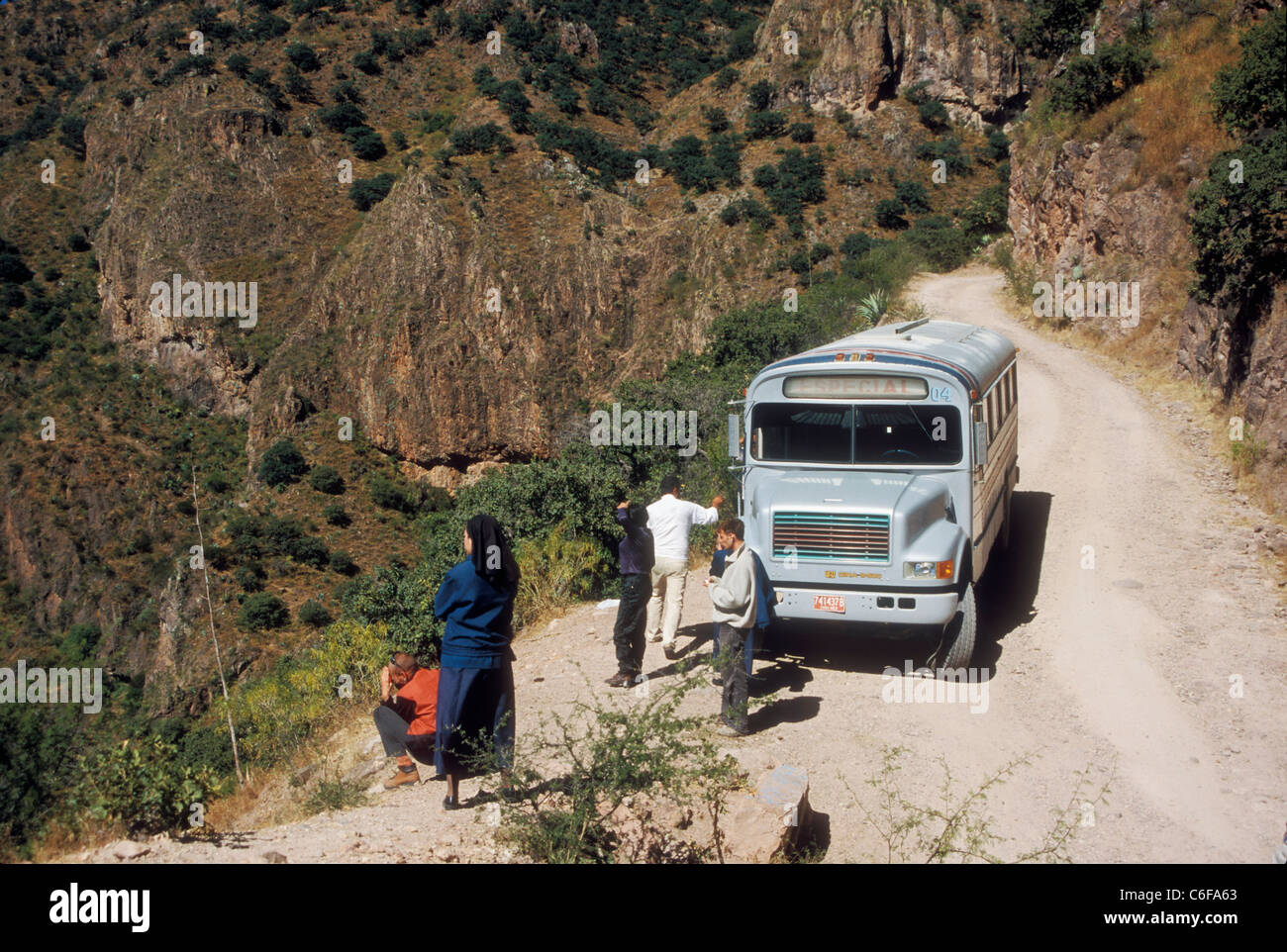 Passengers and driver break the perilous ride down into one of the canyons of the Sierra Madre mountains in northern Mexico Stock Photo