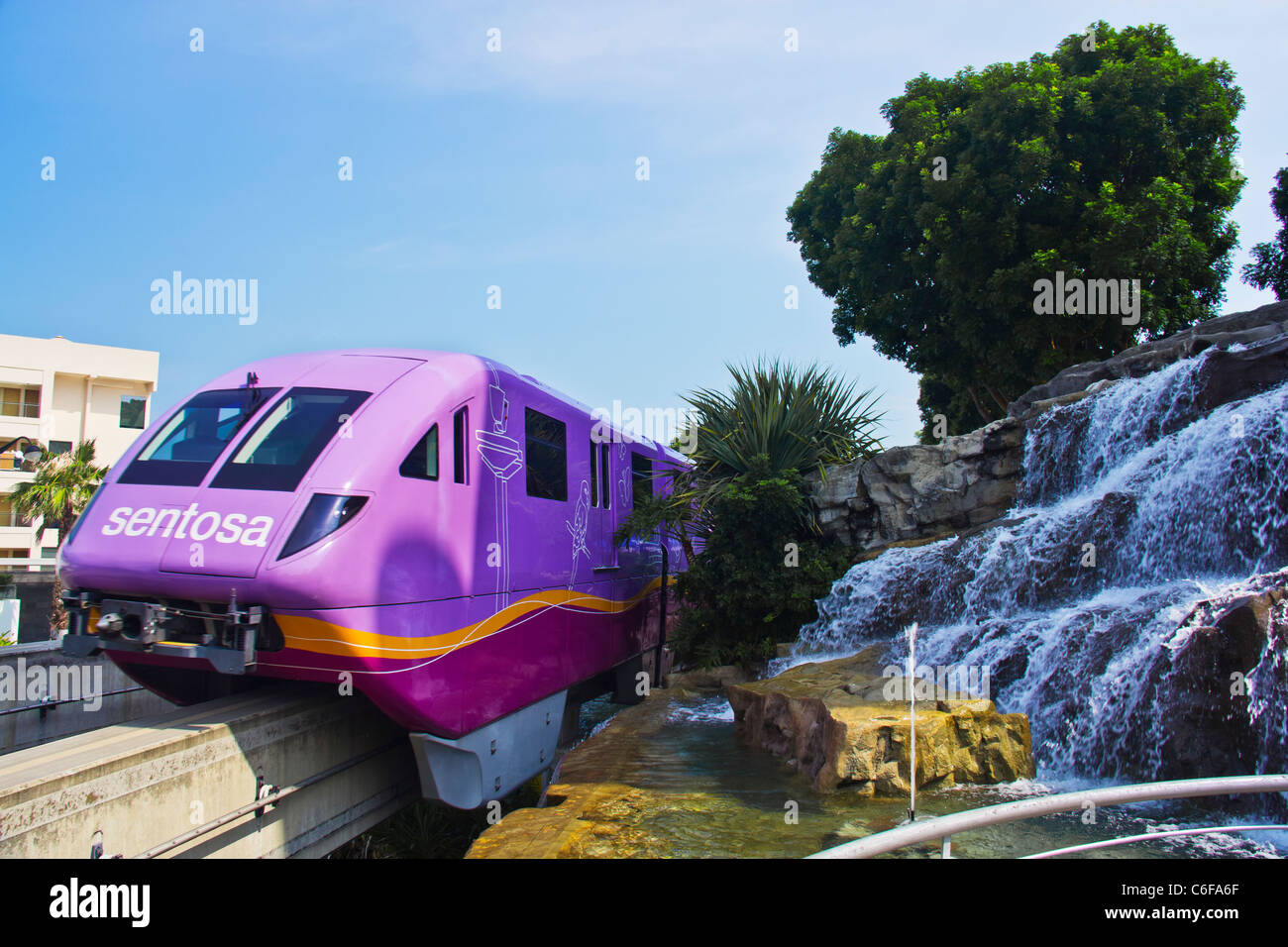 Singapore Sentosa's skytrain passing by the waterfall Stock Photo