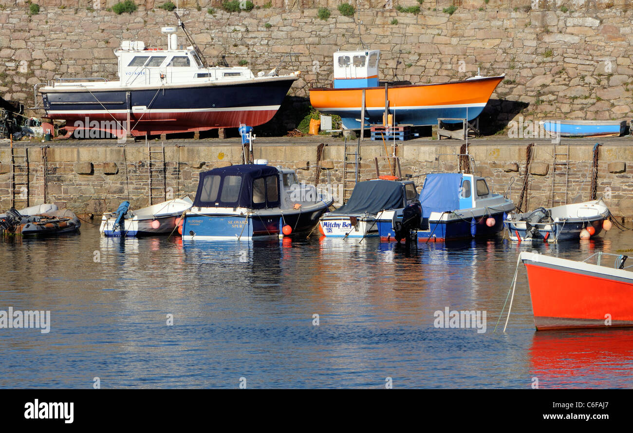 Small boats in and out of the water in  Braye Harbour.  Alderney, Channel Islands, UK. Stock Photo