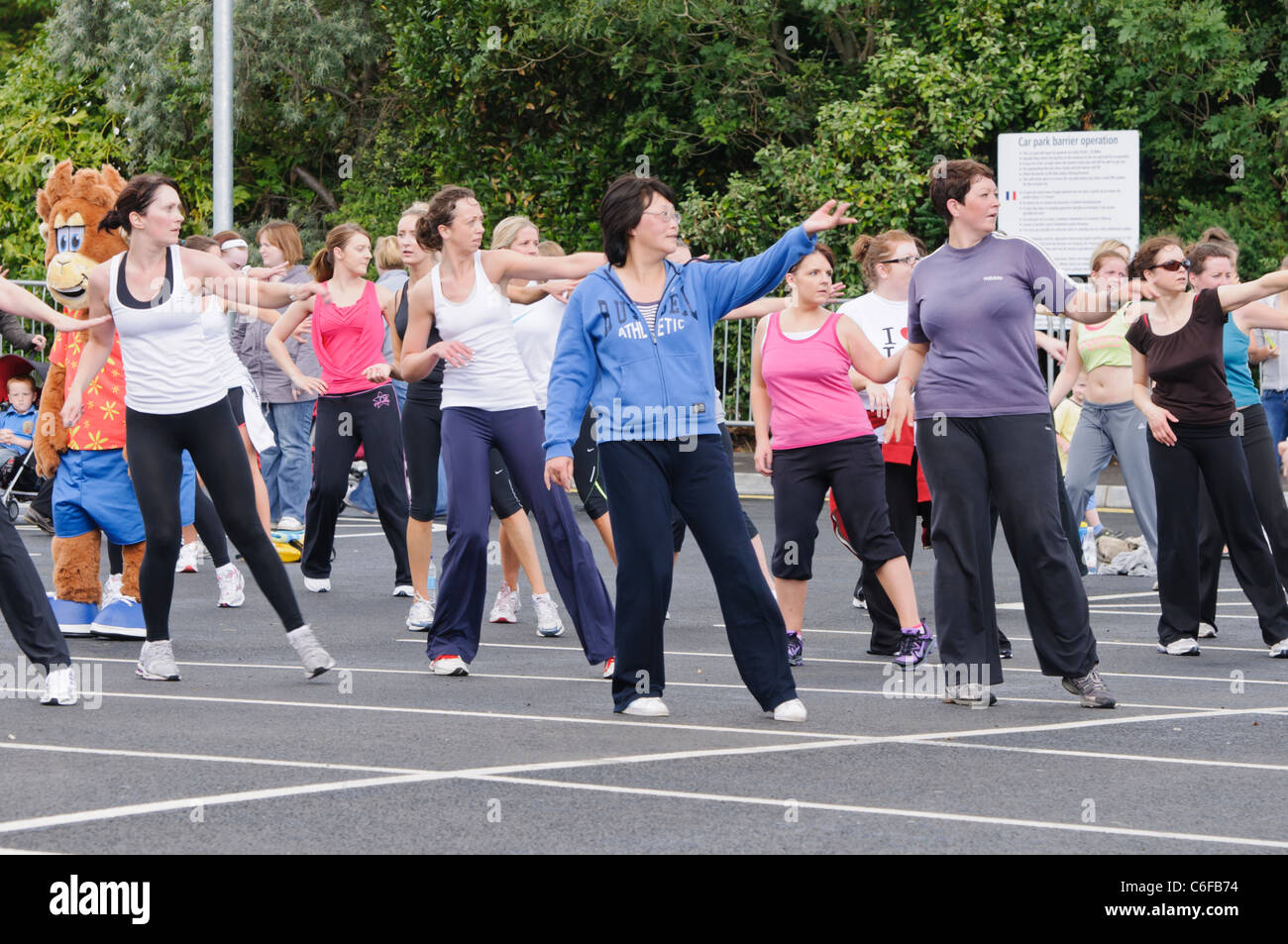 Large number of ladies take part in an outdoor Zumba class Stock Photo
