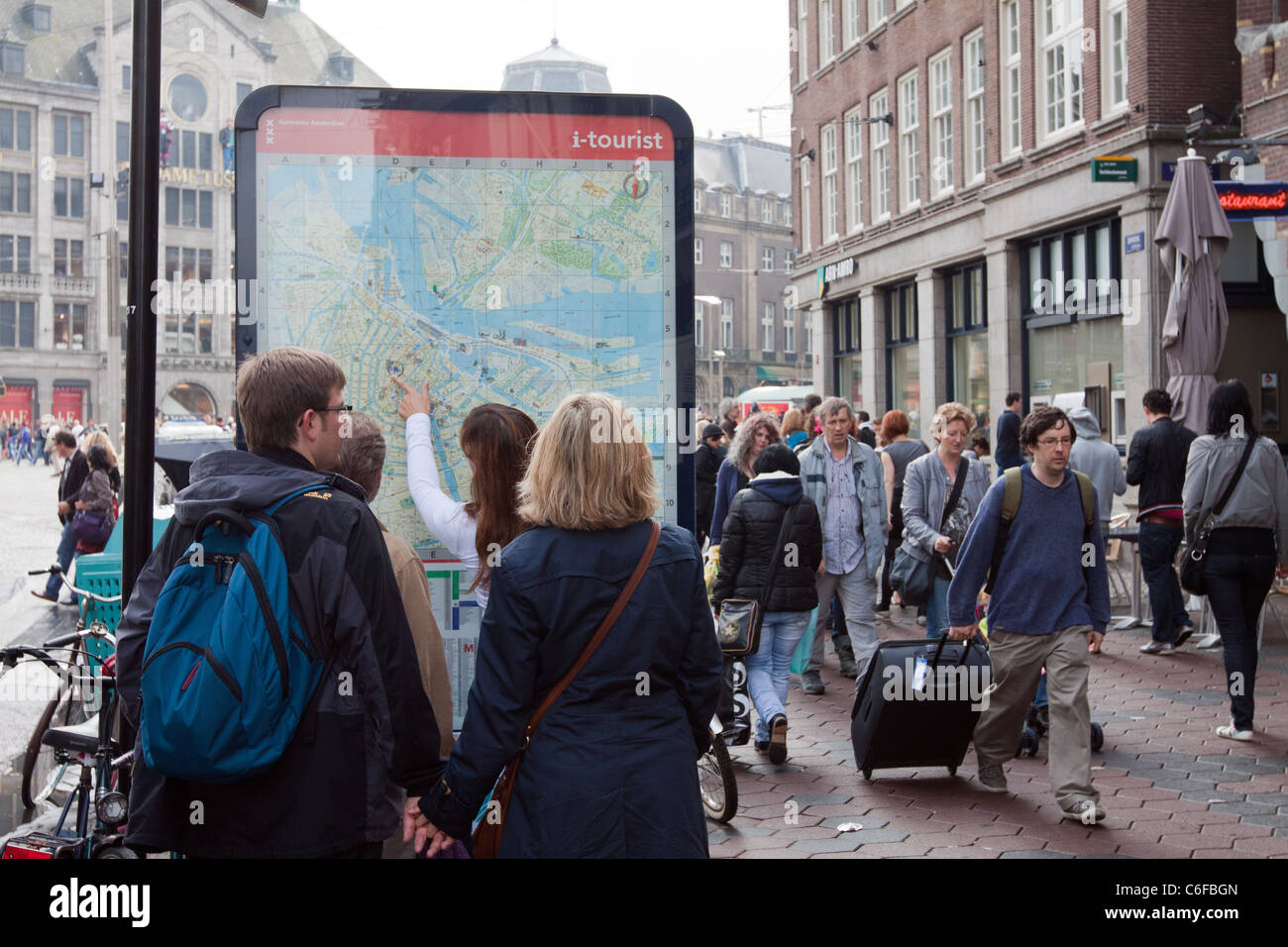 Tourists looking at a map in Amsterdam Stock Photo
