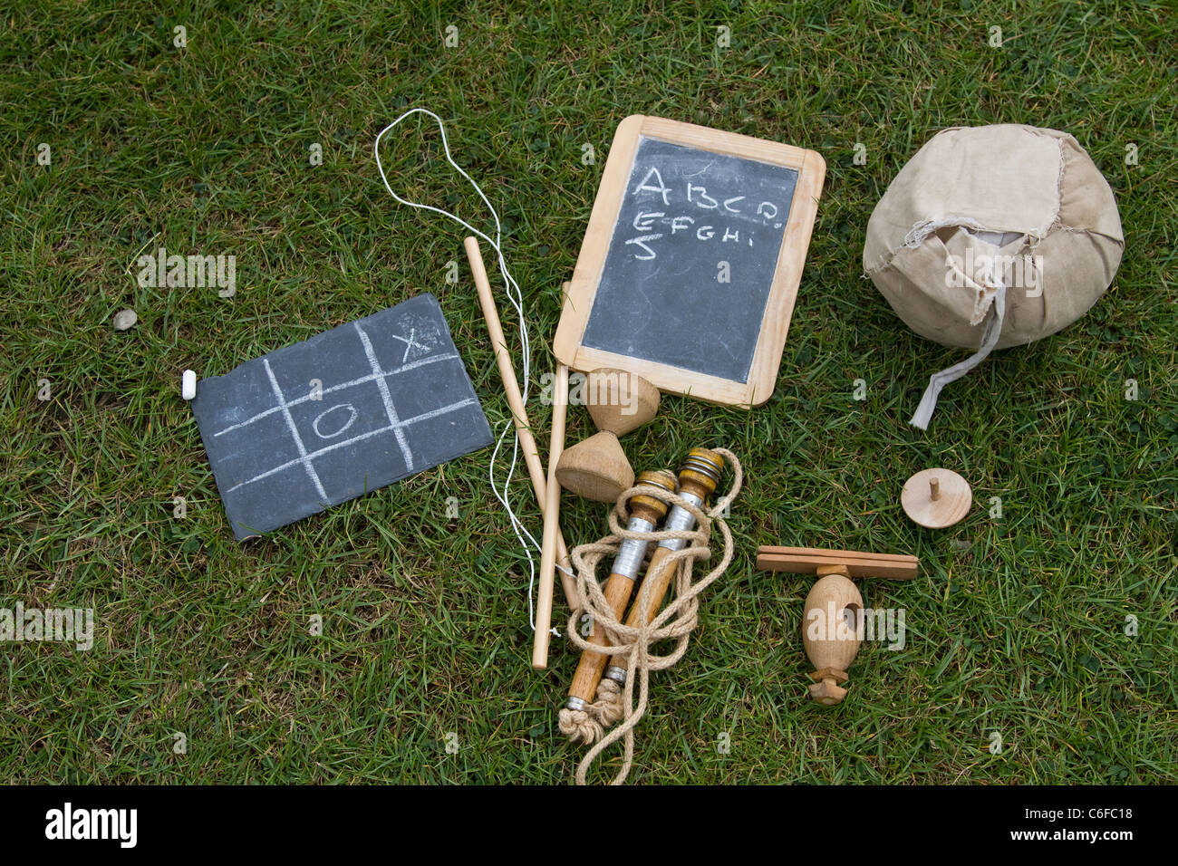 17th Century wooden children's old wood street toys, spinning top, jump-ropes and blackboards; Life & Times Civilian Historical Re-enactment, Tutbury Castle, Derbyshire, UK Stock Photo