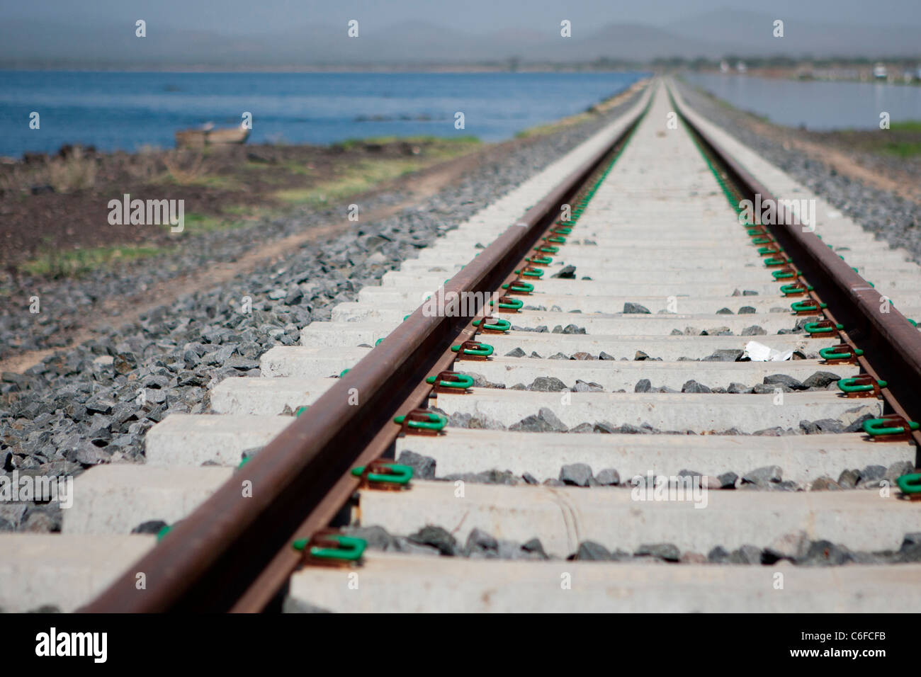 Tracks of the Ethiopia-Djibouti Railway run alongside Lake Basaka in the Awash National Park, Eastern Ethiopia, Africa. Stock Photo